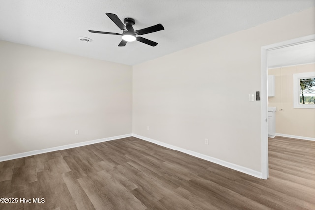 spare room featuring hardwood / wood-style flooring and ceiling fan