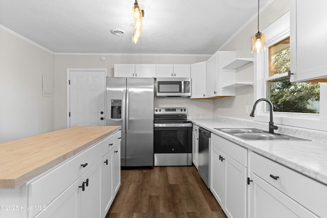 kitchen with white cabinetry, sink, pendant lighting, and appliances with stainless steel finishes