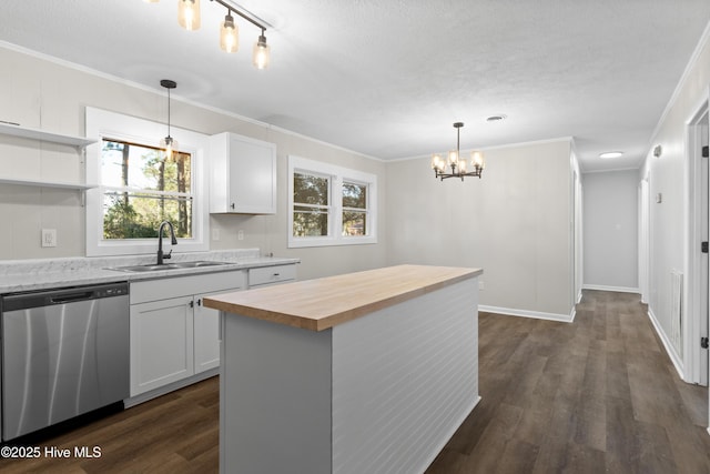 kitchen featuring white cabinetry, decorative light fixtures, dishwasher, and a kitchen island