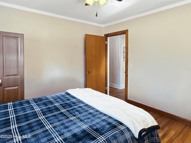 bedroom with ceiling fan, crown molding, and hardwood / wood-style flooring