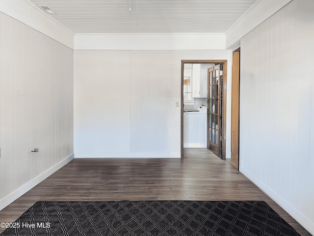 spare room featuring hardwood / wood-style flooring and crown molding