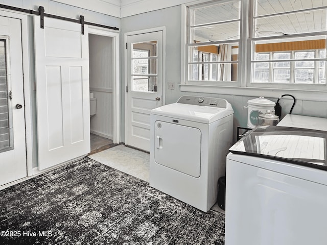 laundry room with washer and clothes dryer and a barn door