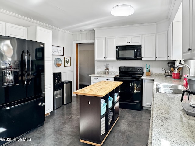 kitchen with black appliances, wooden counters, white cabinetry, sink, and crown molding