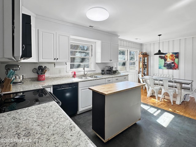 kitchen with a center island, dishwasher, white cabinetry, sink, and wood counters