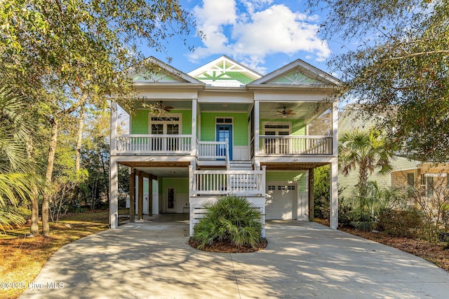 beach home featuring covered porch, ceiling fan, and a carport