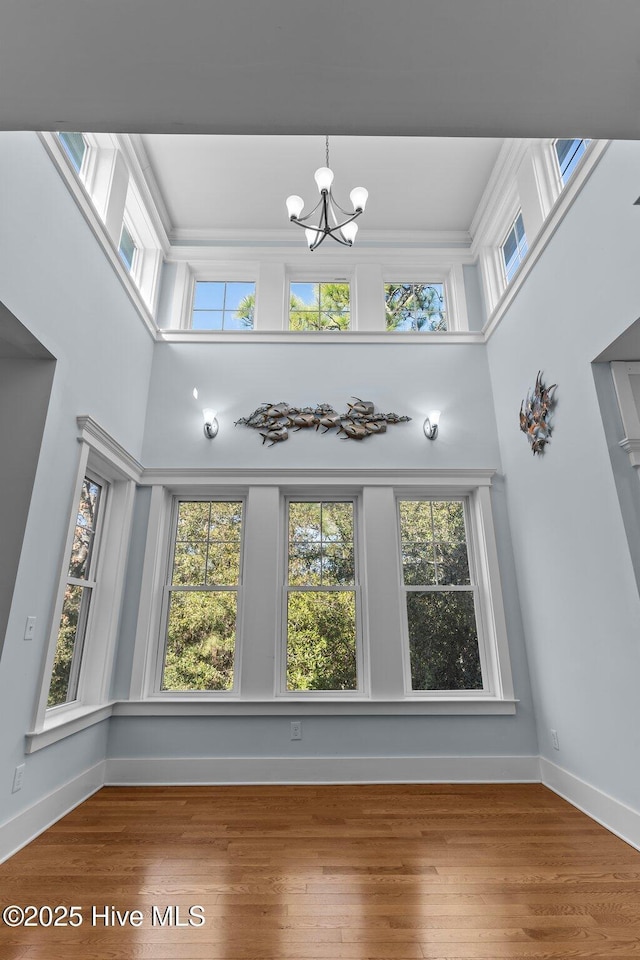 unfurnished sunroom featuring a chandelier and a healthy amount of sunlight