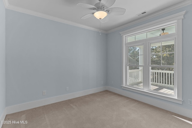 unfurnished room featuring ceiling fan, crown molding, and light carpet