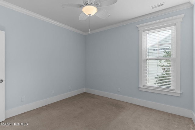 empty room with ceiling fan, crown molding, and light carpet