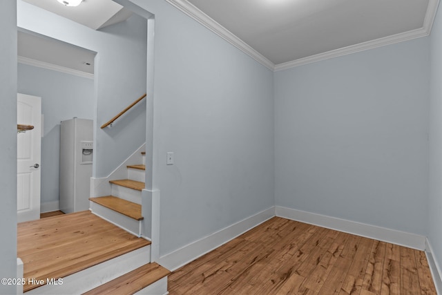 stairway featuring hardwood / wood-style flooring and crown molding