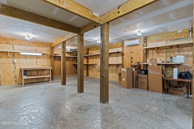 basement featuring an AC wall unit and a workshop area