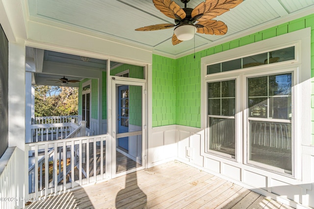 unfurnished sunroom featuring ceiling fan