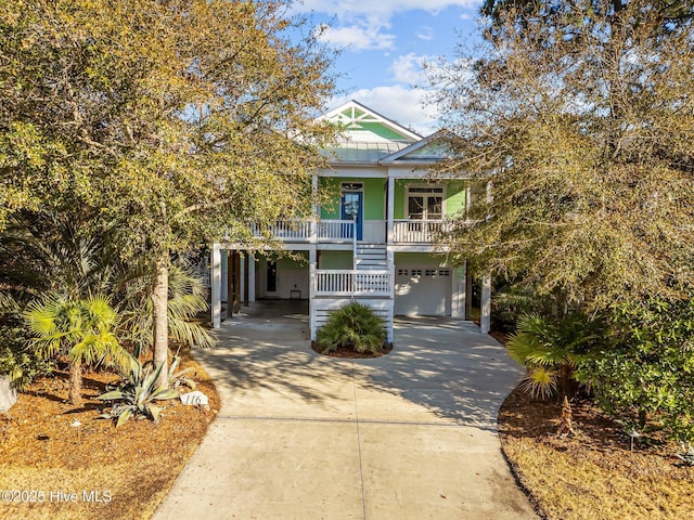 raised beach house with a garage and covered porch