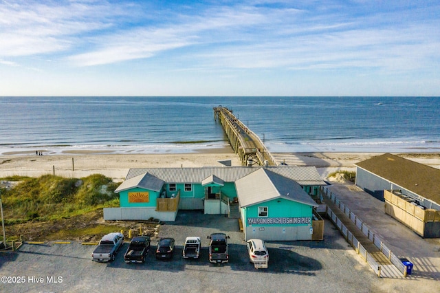 drone / aerial view with a water view and a beach view