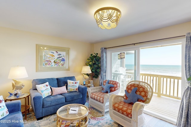 living room featuring a water view, plenty of natural light, and light wood-type flooring