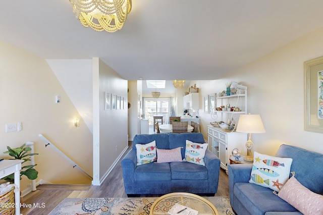 living room with an inviting chandelier and hardwood / wood-style floors