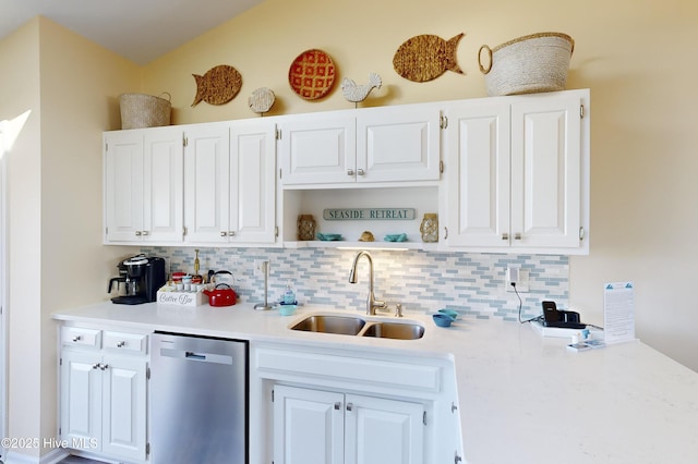 kitchen with tasteful backsplash, white cabinetry, sink, and stainless steel dishwasher