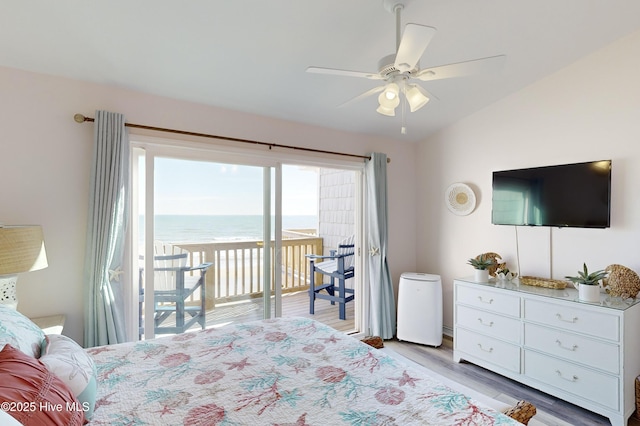 bedroom featuring ceiling fan, lofted ceiling, light wood-type flooring, and access to outside