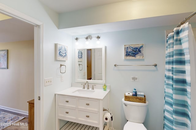 bathroom featuring vanity and toilet