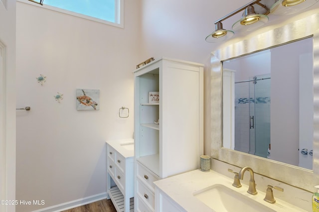 bathroom with vanity and a shower with door