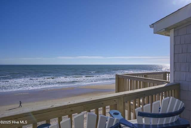 exterior space featuring a water view and a beach view