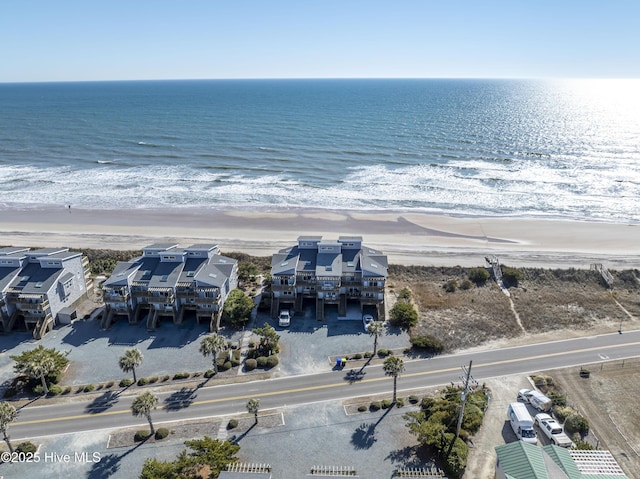 drone / aerial view featuring a water view and a view of the beach