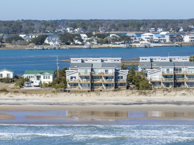 drone / aerial view featuring a view of the beach and a water view