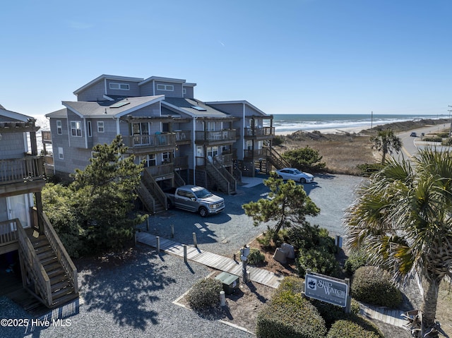 birds eye view of property with a beach view and a water view