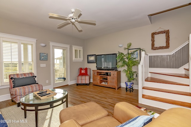 living room with ceiling fan and light hardwood / wood-style flooring