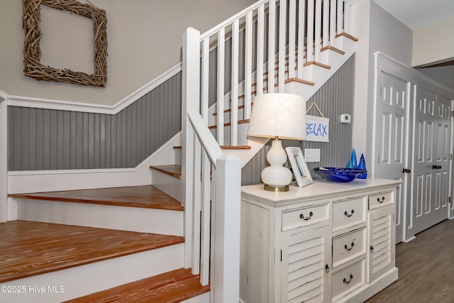 stairway with hardwood / wood-style floors