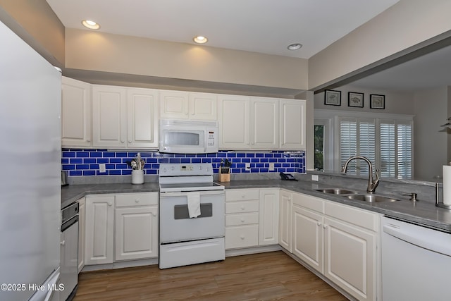 kitchen featuring sink, white appliances, light hardwood / wood-style flooring, and white cabinets