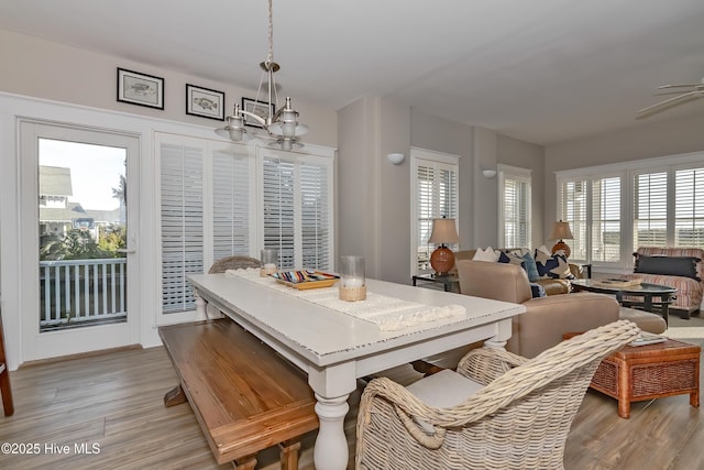 dining space featuring a notable chandelier and light wood-type flooring