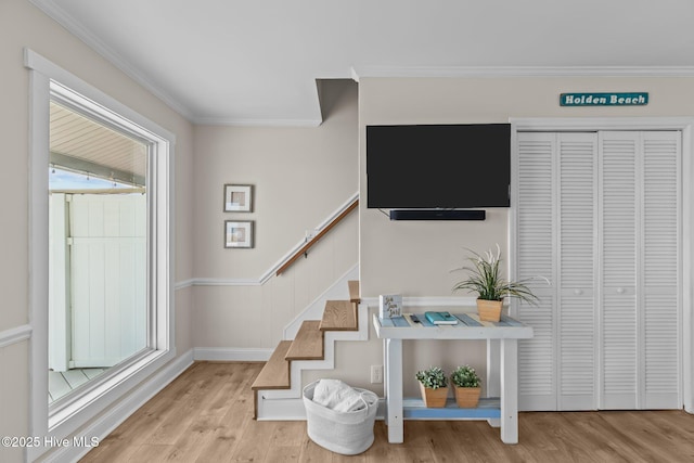 stairway with crown molding and hardwood / wood-style flooring