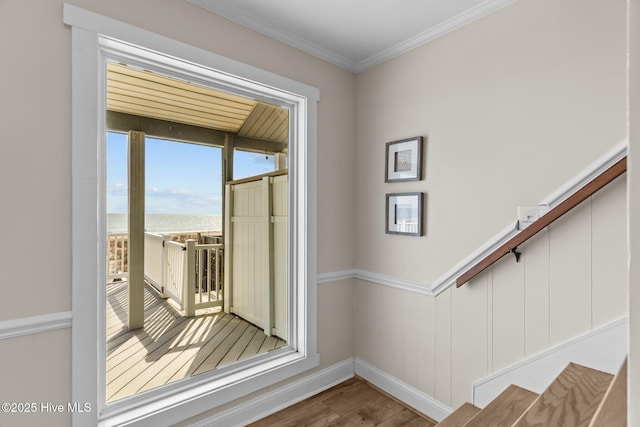 doorway to outside featuring hardwood / wood-style flooring and ornamental molding