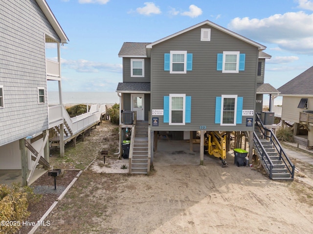 view of front of home with a carport and a water view