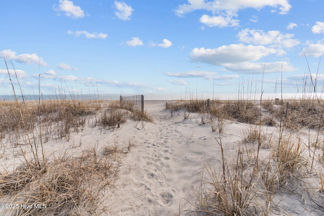 173 Ocean Blvd W # A, Holden Beach, NC 28462 - view of yard featuring view of water and beach and fence