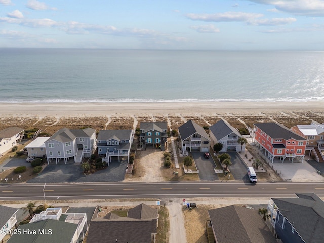 aerial view with a water view and a view of the beach