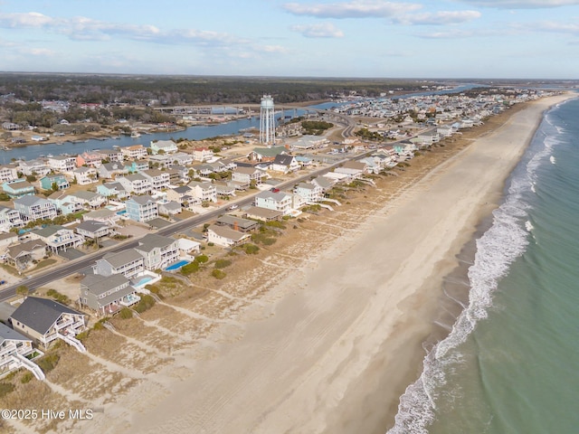 birds eye view of property with a view of the beach and a water view