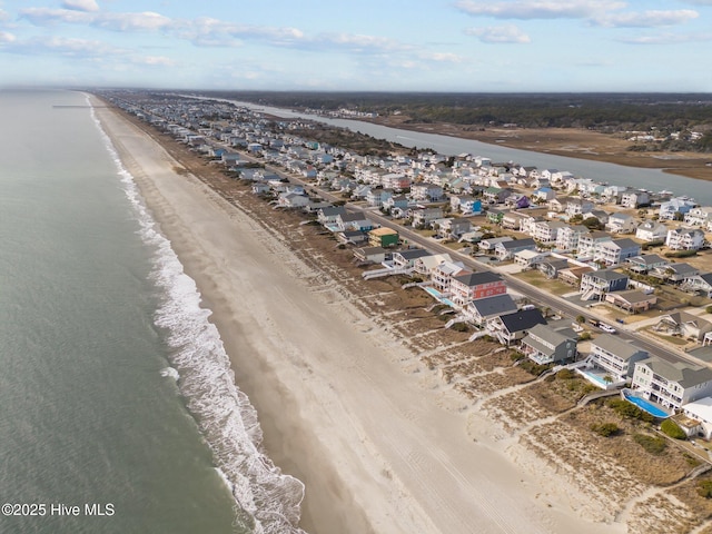 birds eye view of property with a view of the beach and a water view