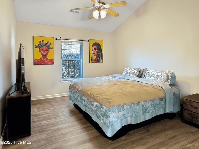 bedroom with wood-type flooring, ceiling fan, and vaulted ceiling