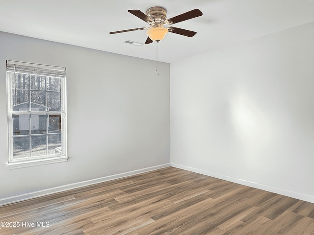 spare room featuring hardwood / wood-style flooring and ceiling fan