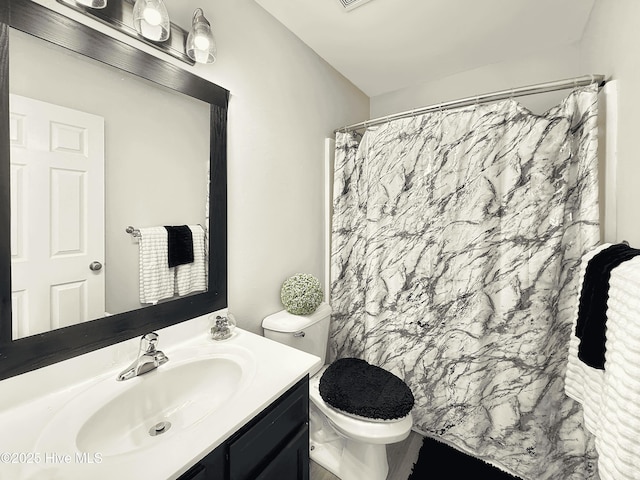 bathroom featuring vanity, toilet, and a shower with shower curtain