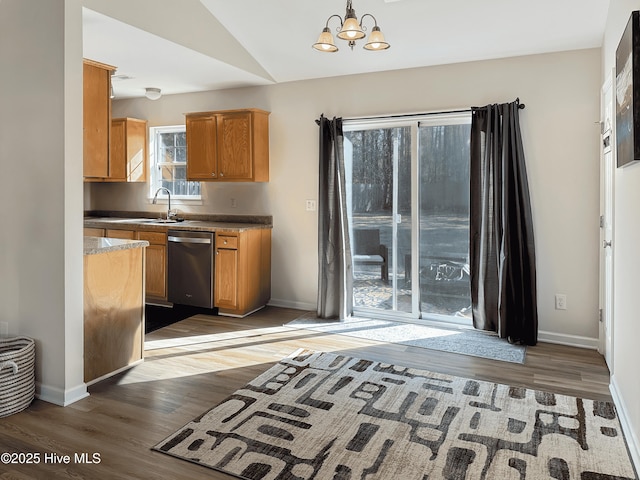 kitchen featuring lofted ceiling, sink, hanging light fixtures, dark hardwood / wood-style flooring, and dishwasher