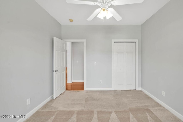 unfurnished bedroom with a closet, ceiling fan, and light carpet