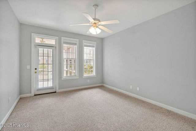 spare room with carpet floors and ceiling fan