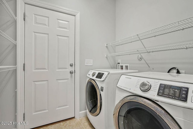 laundry room with separate washer and dryer and light tile patterned floors