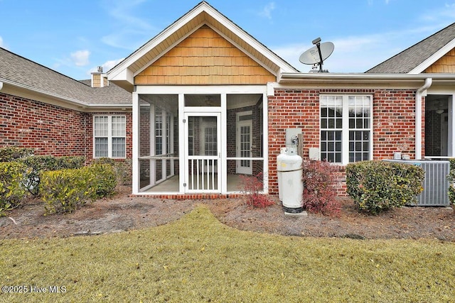 back of house with cooling unit, a lawn, and a sunroom