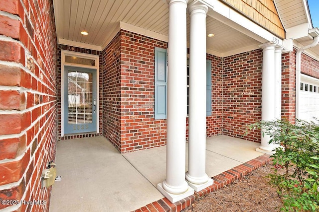 view of exterior entry with a garage