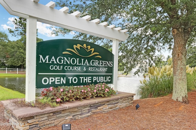 community / neighborhood sign featuring a water view