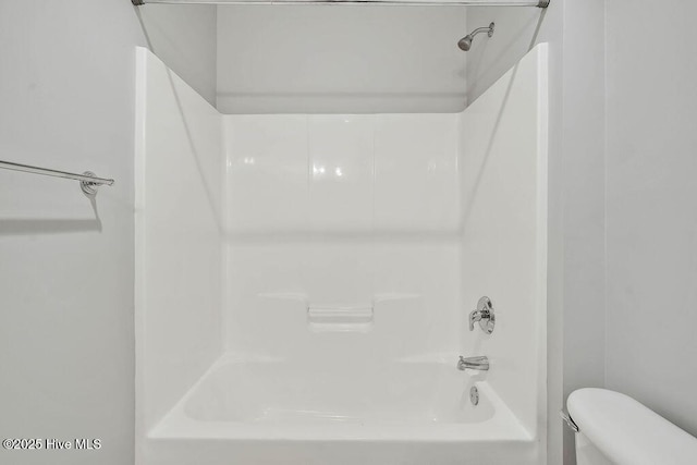 bathroom with toilet and  shower combination