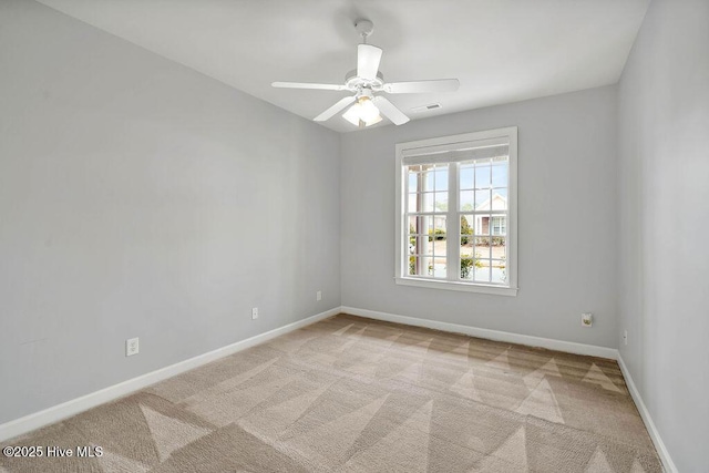 carpeted empty room featuring ceiling fan